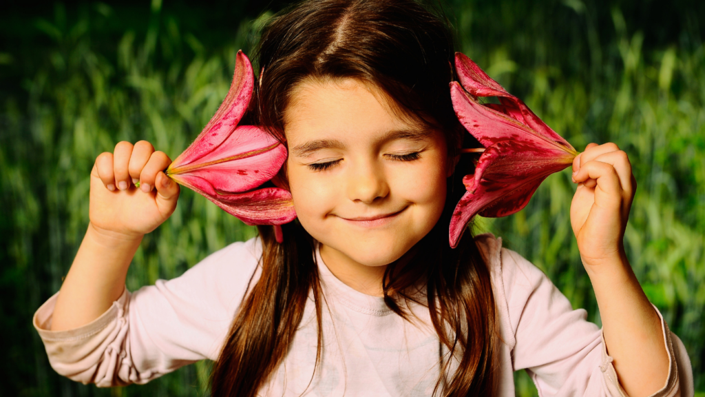 Girl hearing sound through flowers