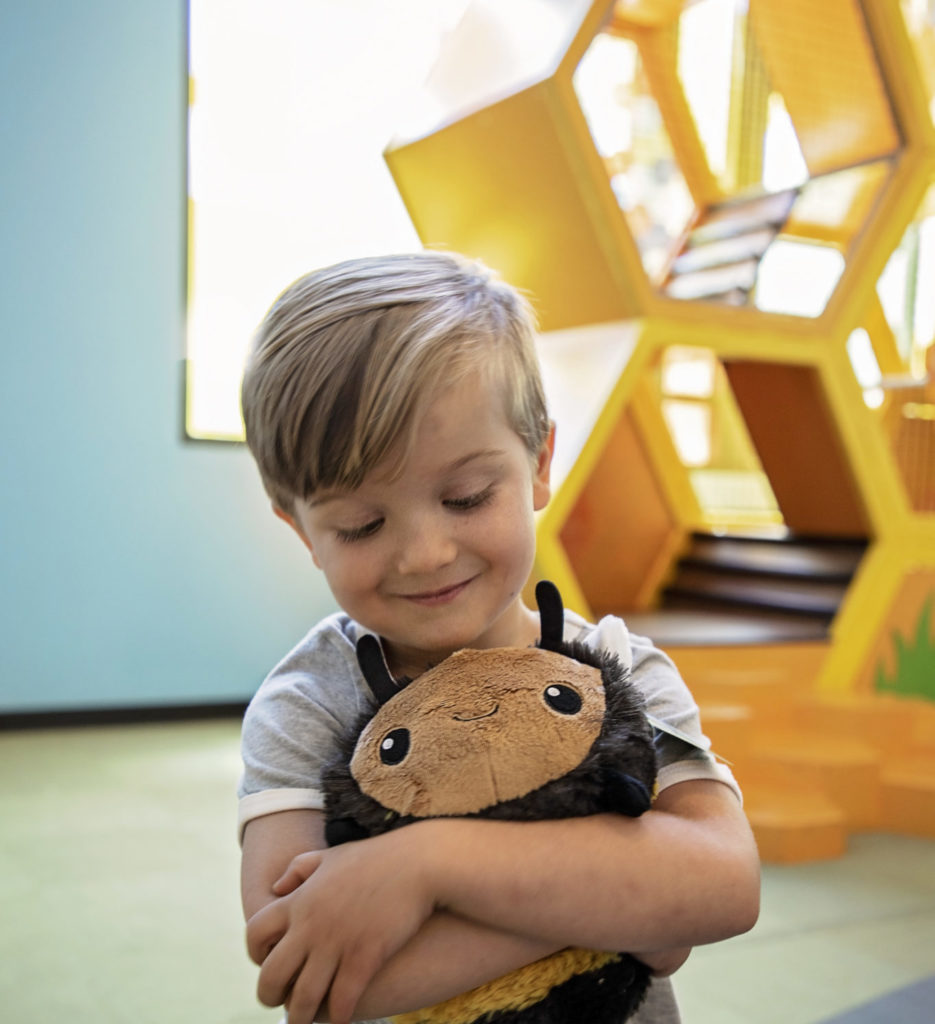 Kid holding stuffy in the museum