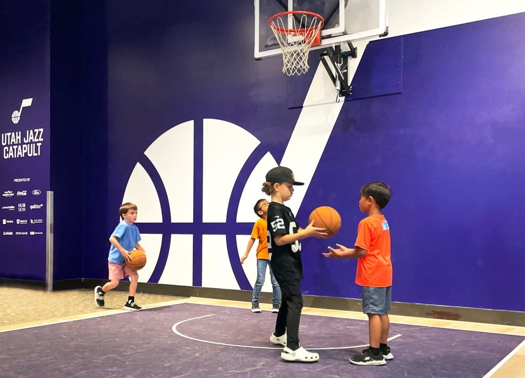 Kids playing basketball together at the museum