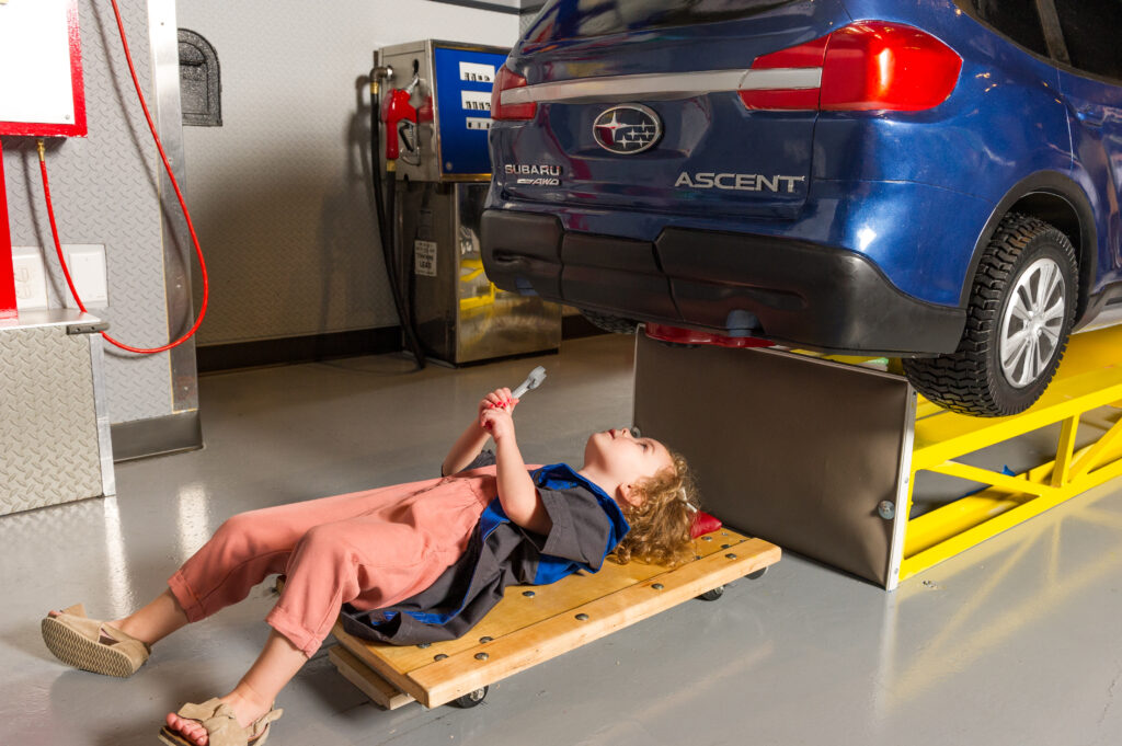 Kids Fixing Car at Subaru Exhibit Image