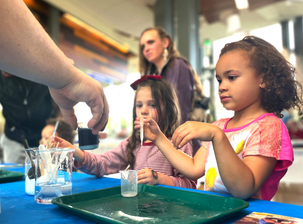 Kids participate in Color Change experiment in city Library