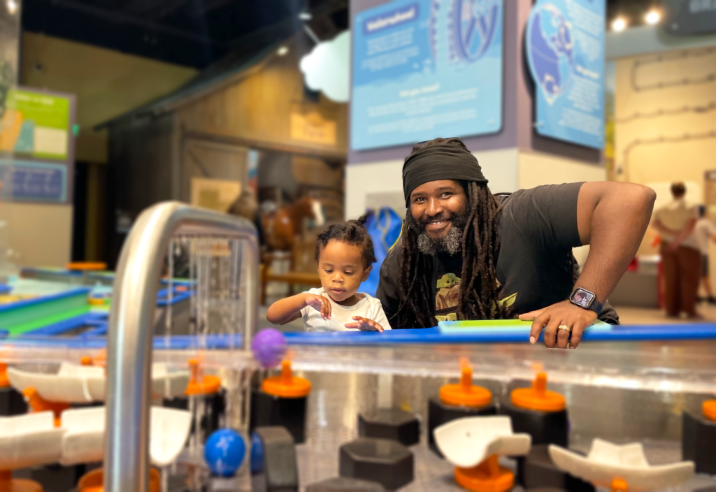 Father and son participating at Water Play at the museum