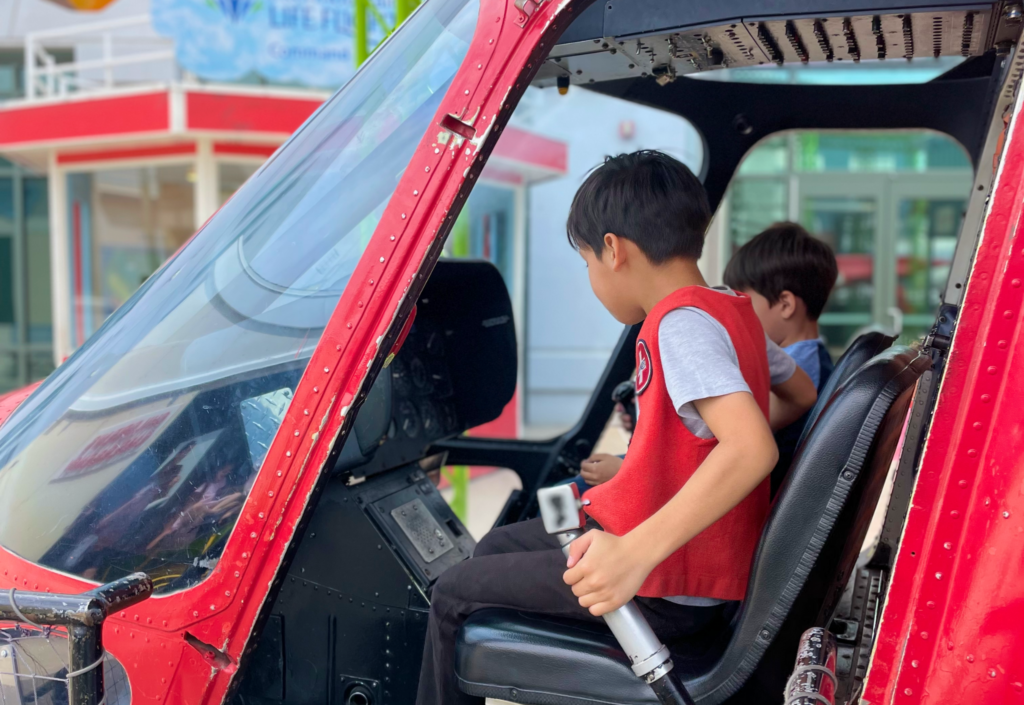 Kids playing at helicopter section at the museum