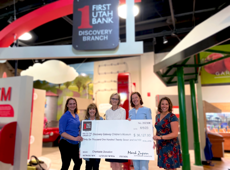 Museum CEO posing in picture with First Utah Bank Sponsors and Museum Staffs