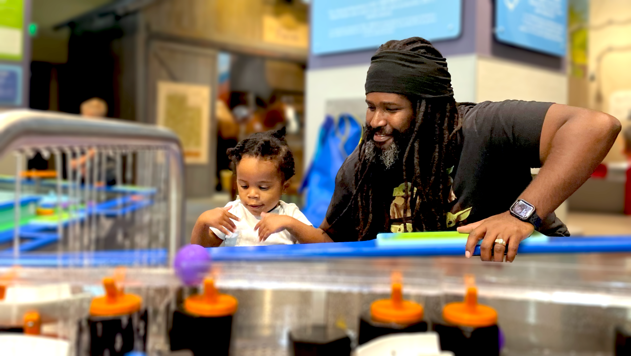 Father and Son at Water Play Section in the Museum