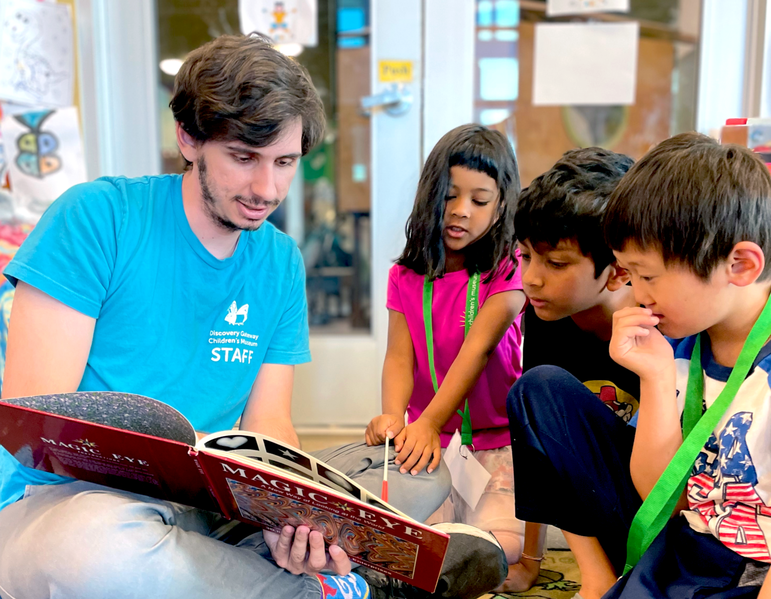 Museum staff read stories to kids during summer camp