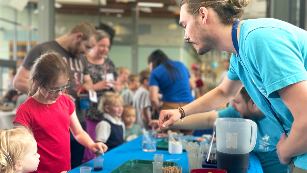 Outreach educator with kids at public library