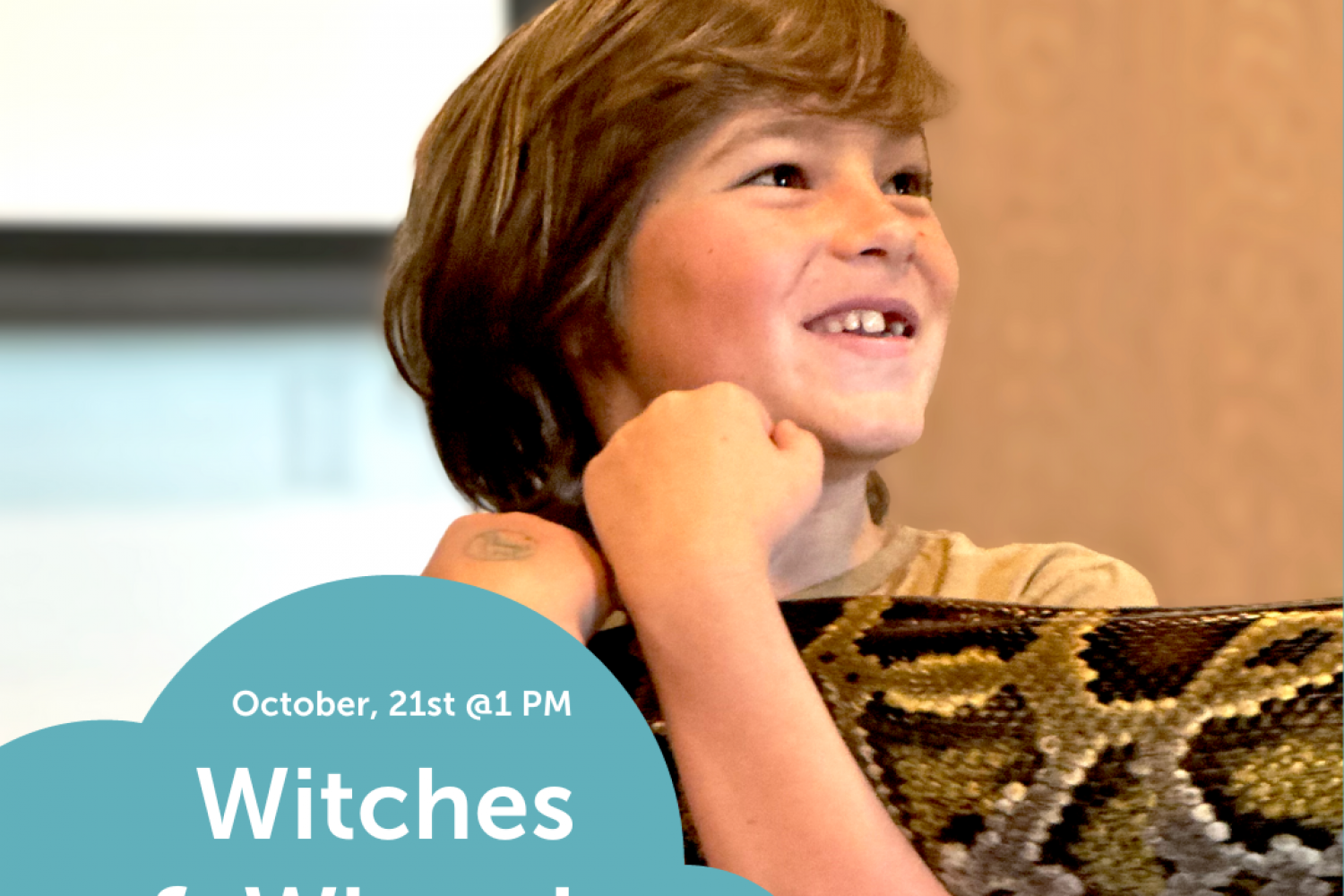 Young boy holding a snake at Scales and Tails Event