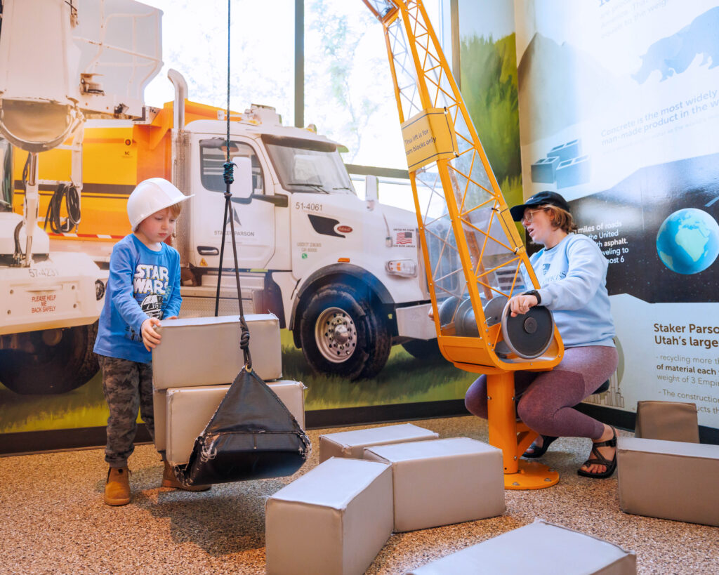 Child and adult build with blocks at the construction exhibit in Discovery Gateway Children’s Museum, Salt Lake City.